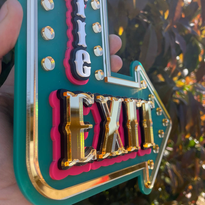 Dramatic Exit arrow wall sign in teal and hot pink layered acrylic, whimsical statement wall decor for eclectic homes.